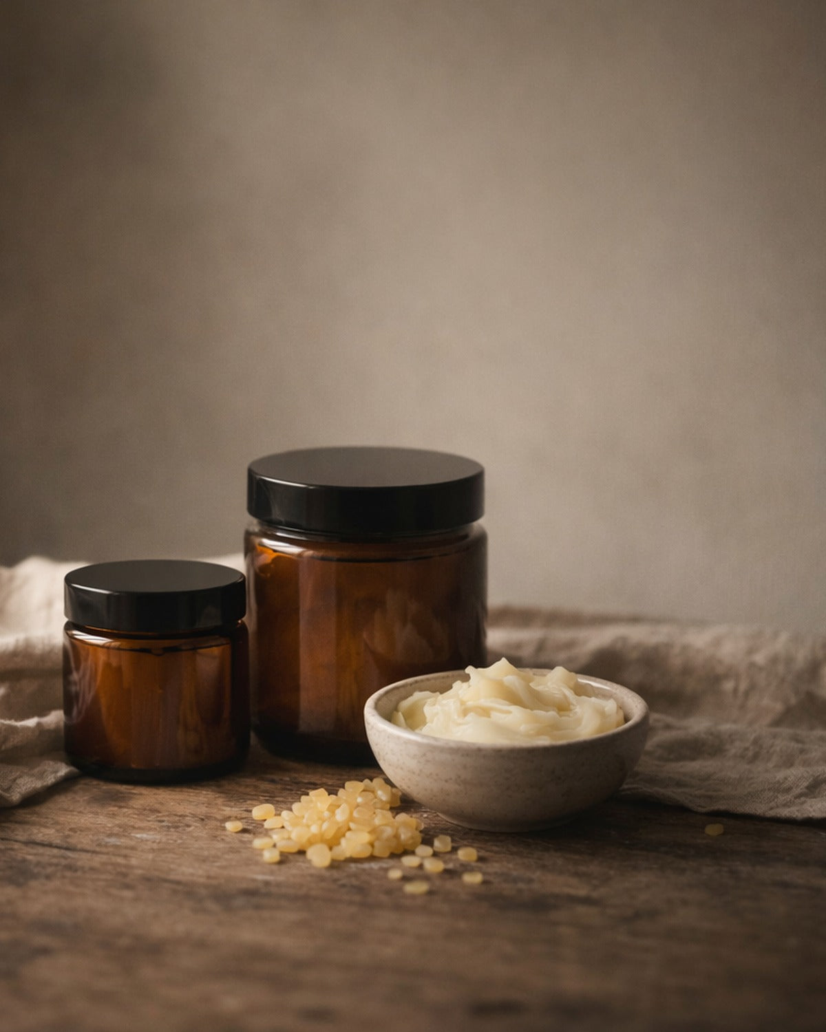 Amber glass tallow balm jars with beeswax in warm natural light